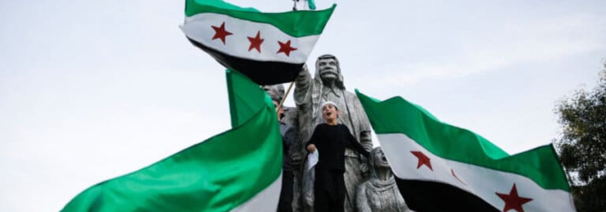 People celebrate next to a sculpture of Sultan Pasha al-Atrash, a Druze warrior who led a revolt against French rule in 1925, after Syrian rebels announced that they had ousted President Bashar al-Assad, in Majdal Shams, a Druze village in the Israeli-occupied Golan Heights, December 9, 2024.,Image: 944744460, License: Rights-managed, Restrictions: , Model Release: no, Credit line: Shir Torem / Reuters / Forum