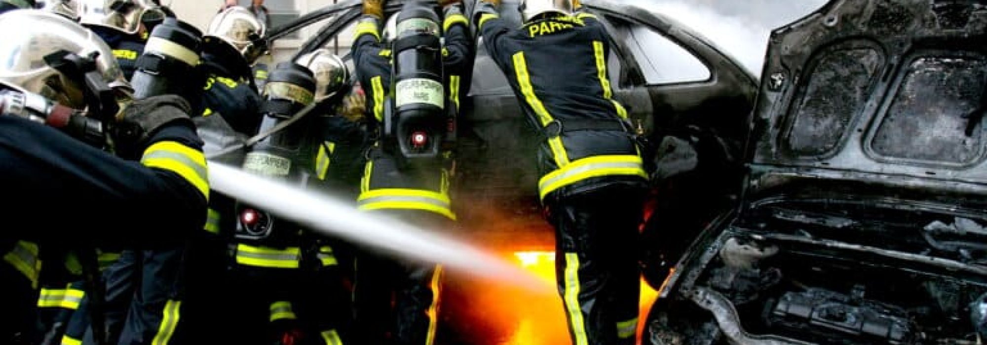 Firemen extinguish a burning car set on fire at the end of a student demonstration in Paris March 23, 2006. Rampaging French youths set fire to cars and looted shops in Paris on Thursday, marring protests against a youth jobs law, also known as the CPE, that [Prime Minister Dominique de Villepin], in a conciliatory move, agreed to discuss with unions.,Image: 793358949, License: Rights-managed, Restrictions: , Model Release: no, Credit line: Jacky Naegelen / Reuters / Forum